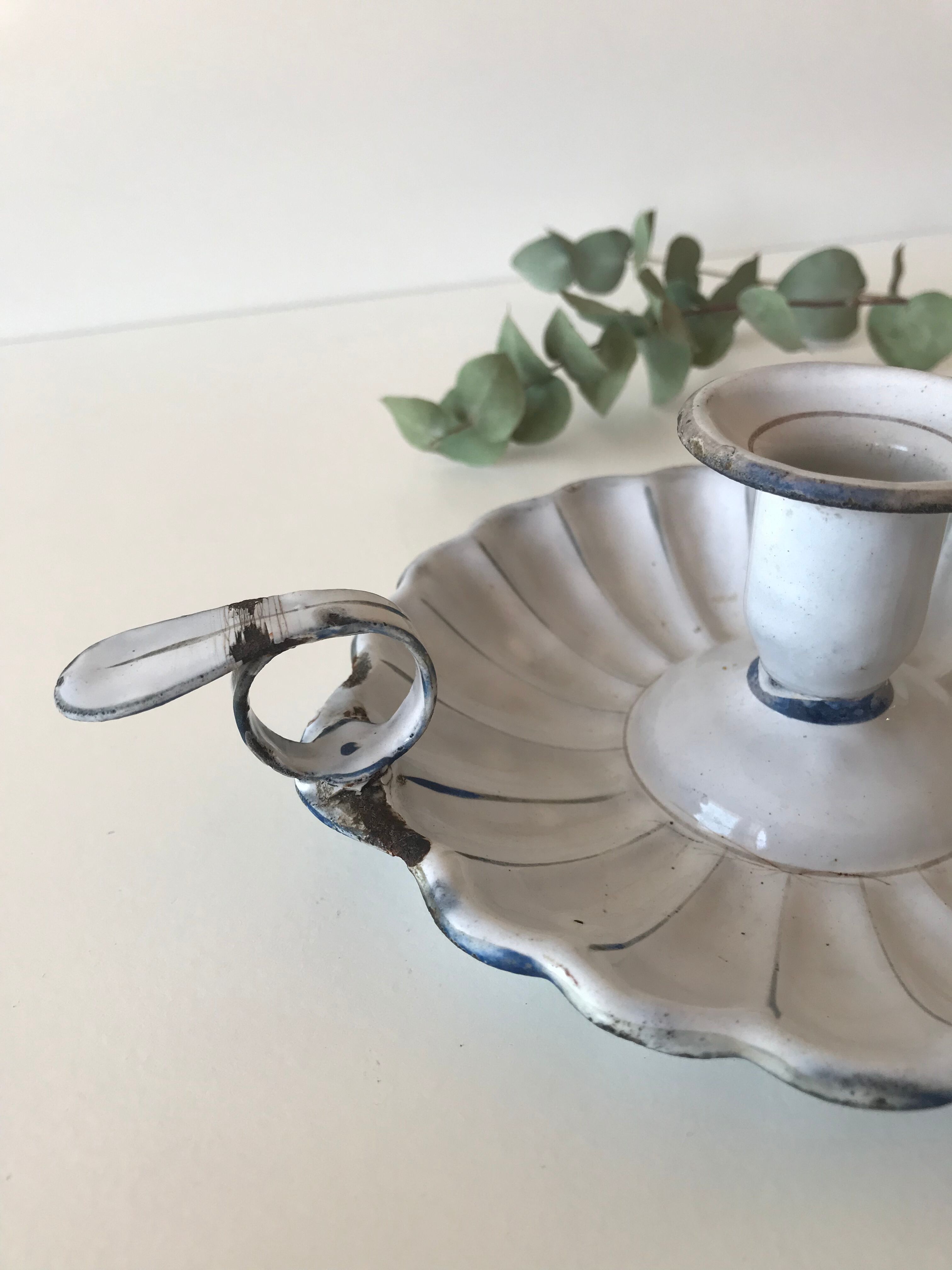 Candlestick in white enameled metal