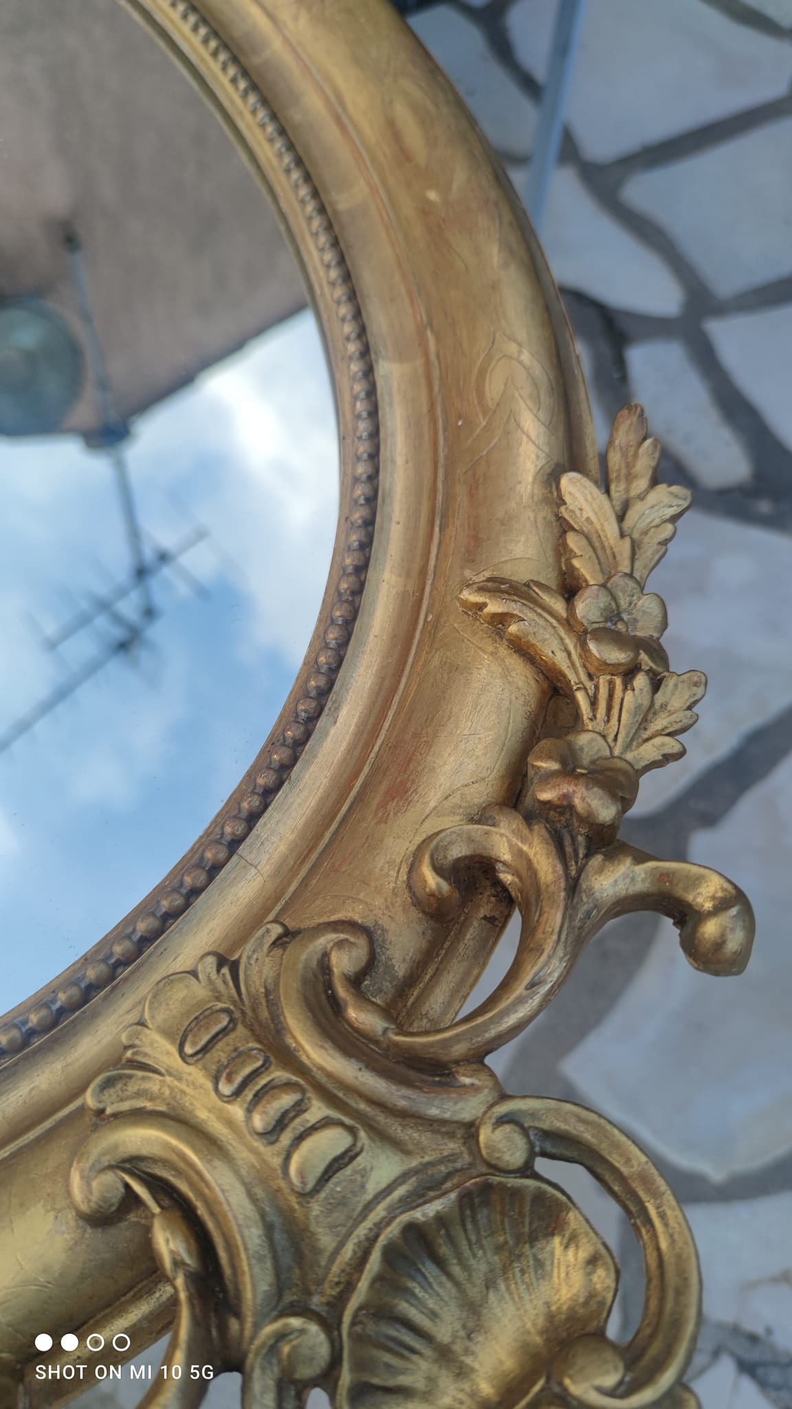 Ovoid mirror with double gilt pediments, circa 1830, 105x66 cm