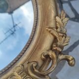 Ovoid mirror with double pediments gilded with leaf circa 1830, 105x66 cm