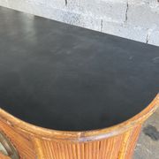 Rattan and wood bar with its decorative brass portholes