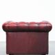 Red English cowhide Chesterfield armchair finished with decorative nails