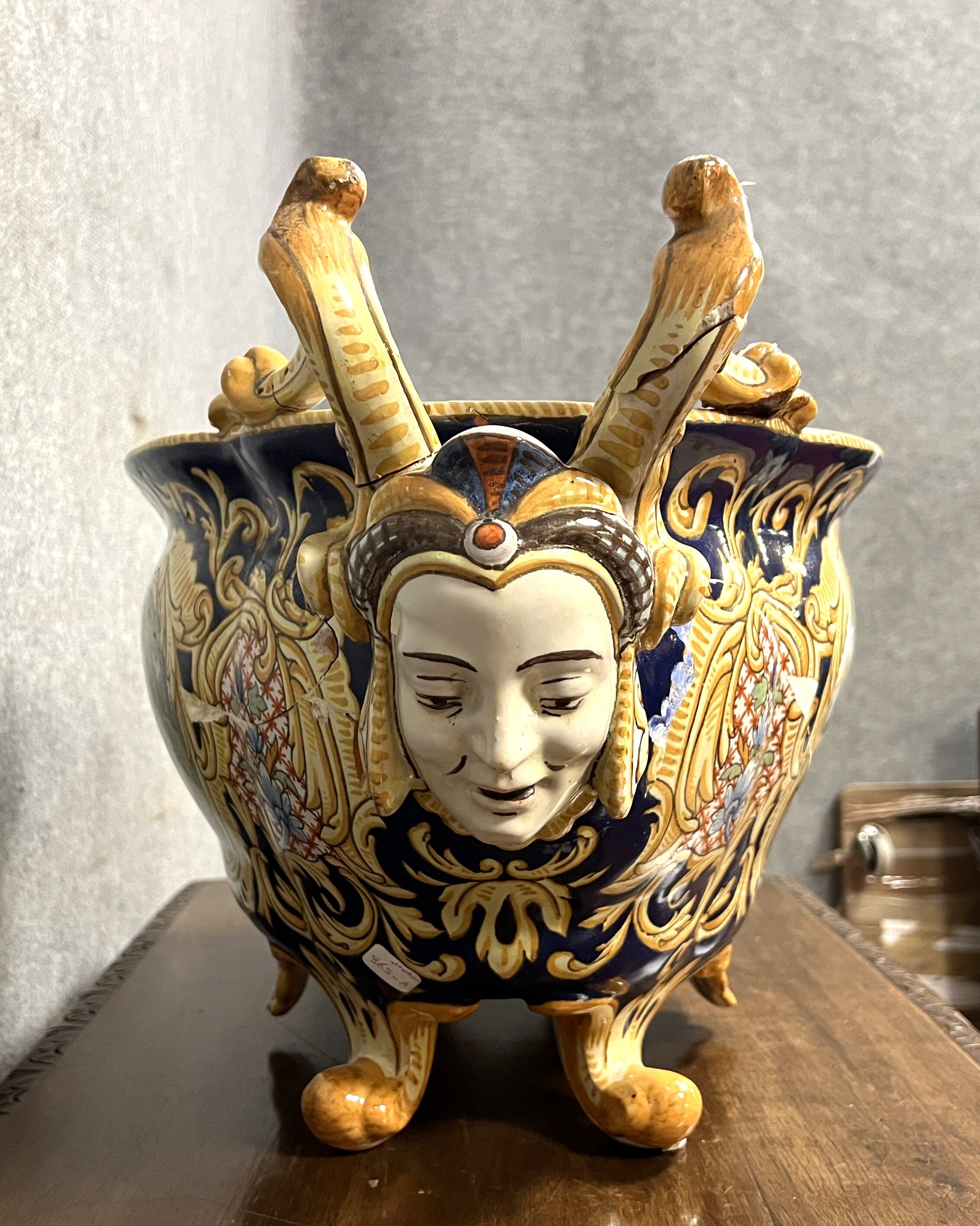 Earthenware planter with polychrome enamelled decoration on a blue background