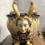 Earthenware planter with polychrome enamelled decoration on a blue background