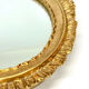 Antique oval mirror in gilded wood