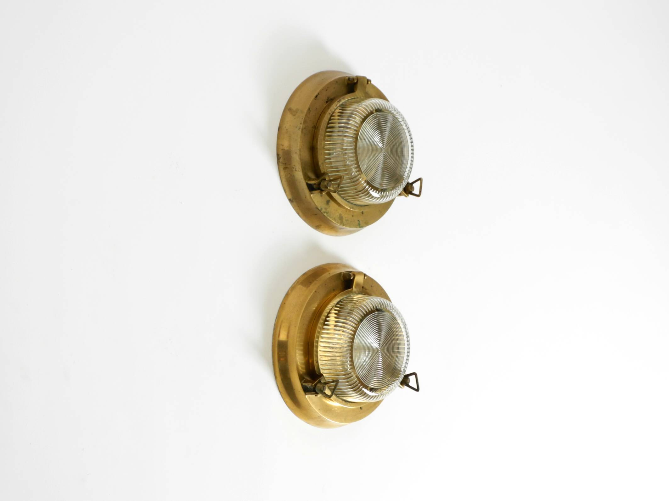 A pair of large, heavy 50s maritime ship wall lamps made of brass and glass