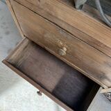 Column storage unit with a sculpted metal door.