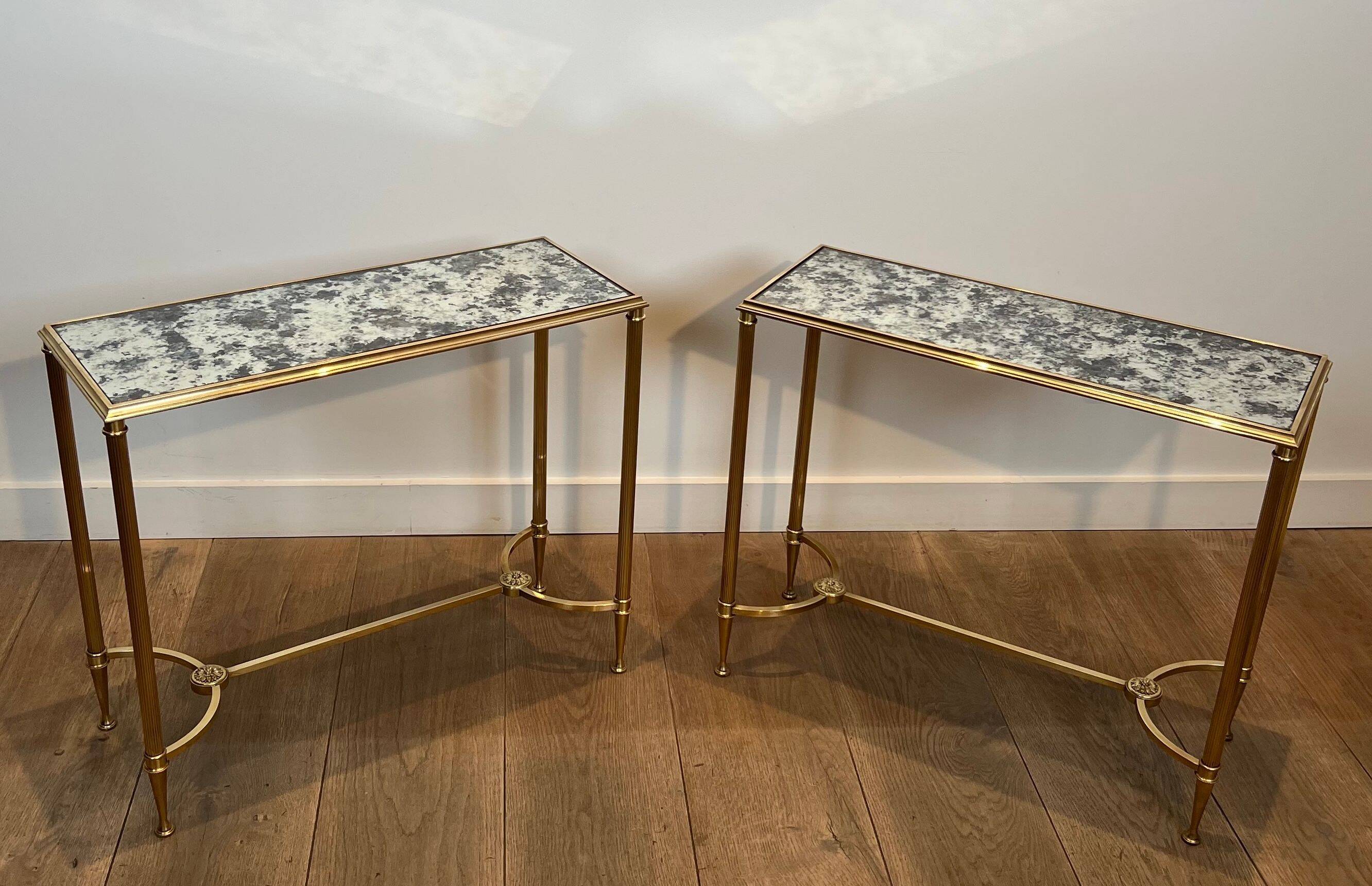 Pair of brass and antique mirror side tables from the Baguès house.