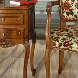 Convertible armchair with brocade fabric and floral patterns.