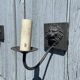 Two lion head wall sconces in tin.