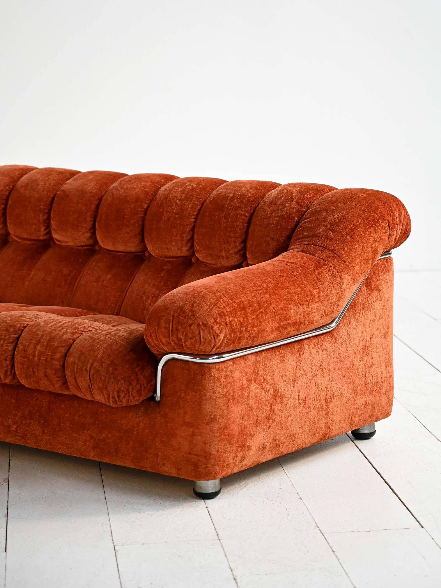 Vintage rust velvet sofa from the 1970s with metal details.