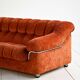 Vintage rust velvet sofa from the 1970s with metal details.