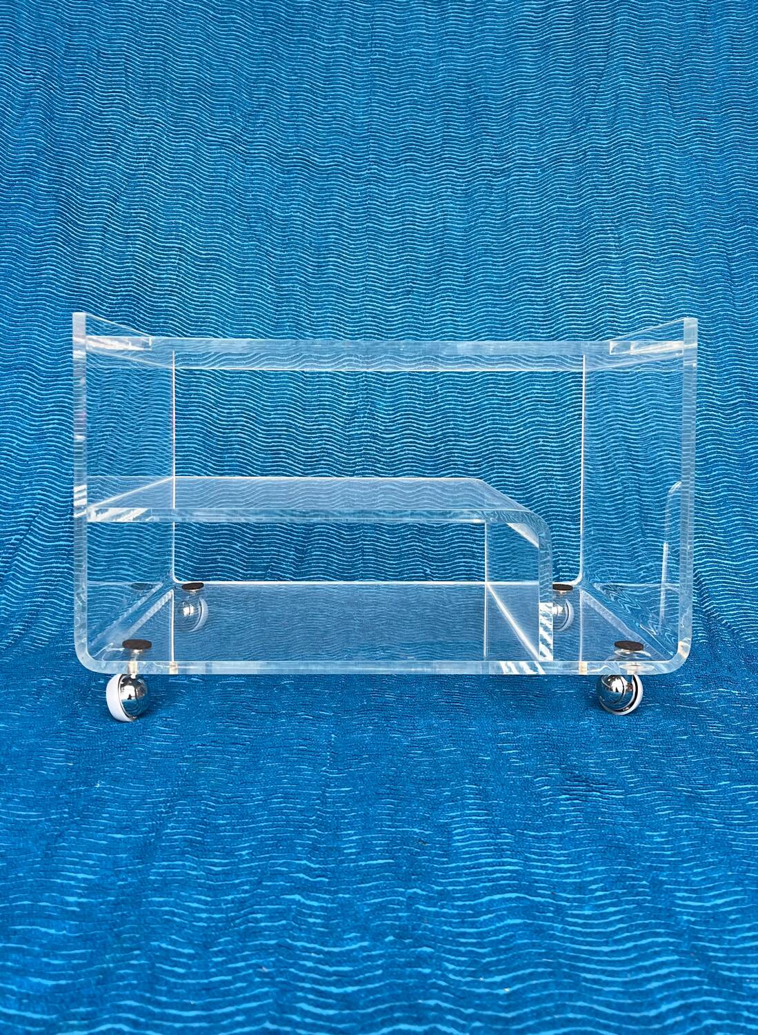 Translucent plexiglass storage drawer/cabinet on wheels.