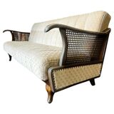 Vintage wooden armchair with rattan weaving.