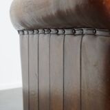 Sheepskin leather armchair in a cognac color with black piping