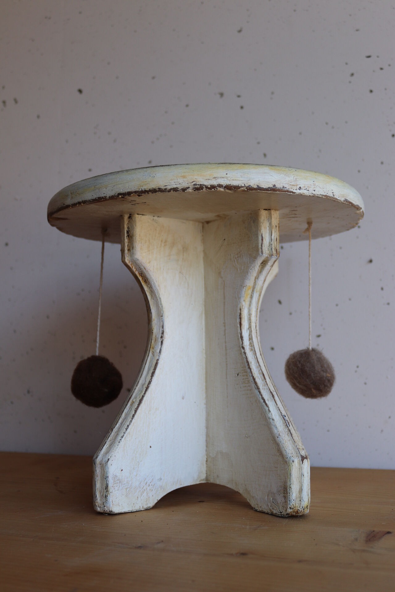 Small wooden stool painted with a star design.