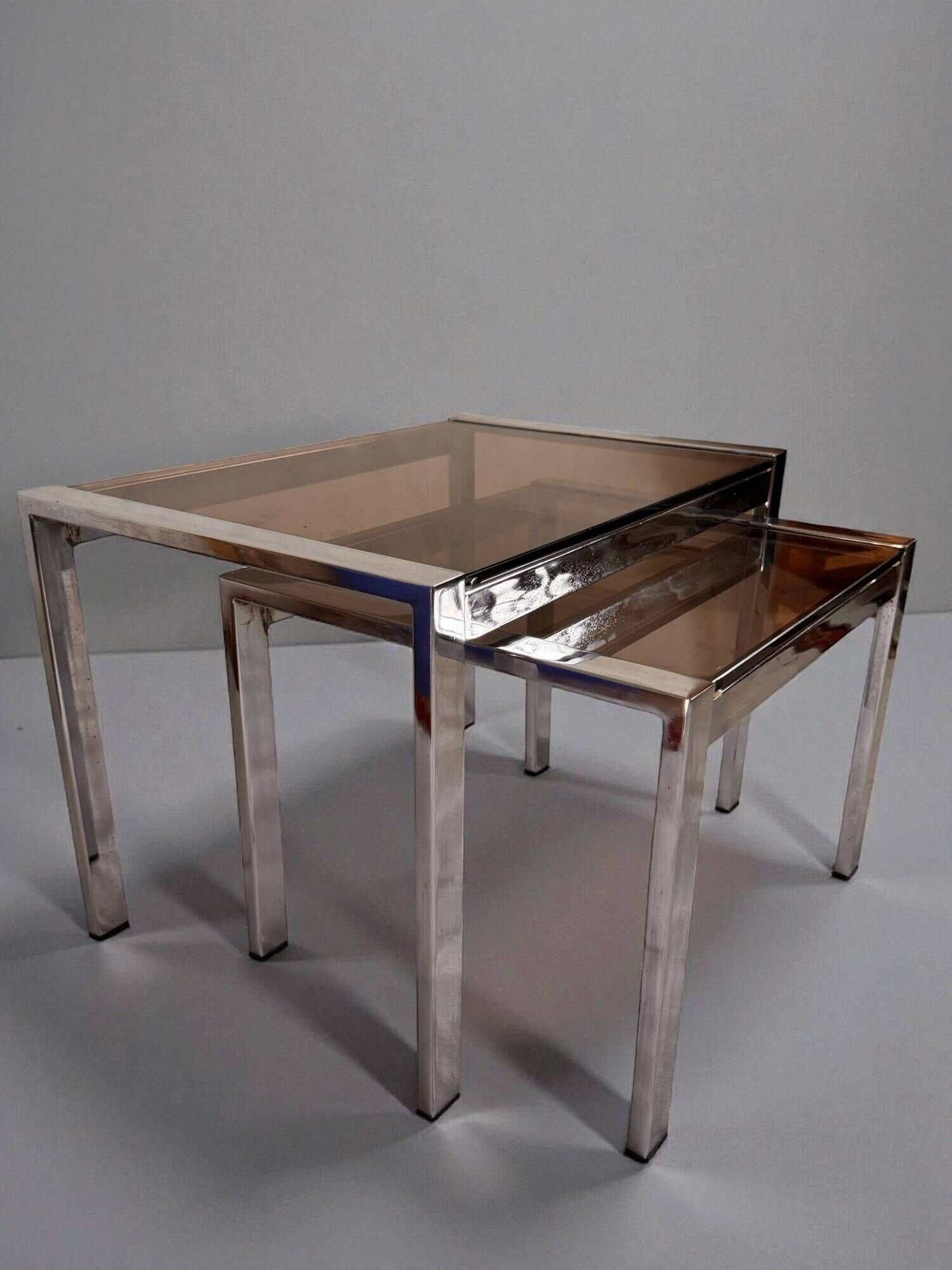 Vintage 1970s nesting tables in chrome and smoked glass, mid-century modernist style