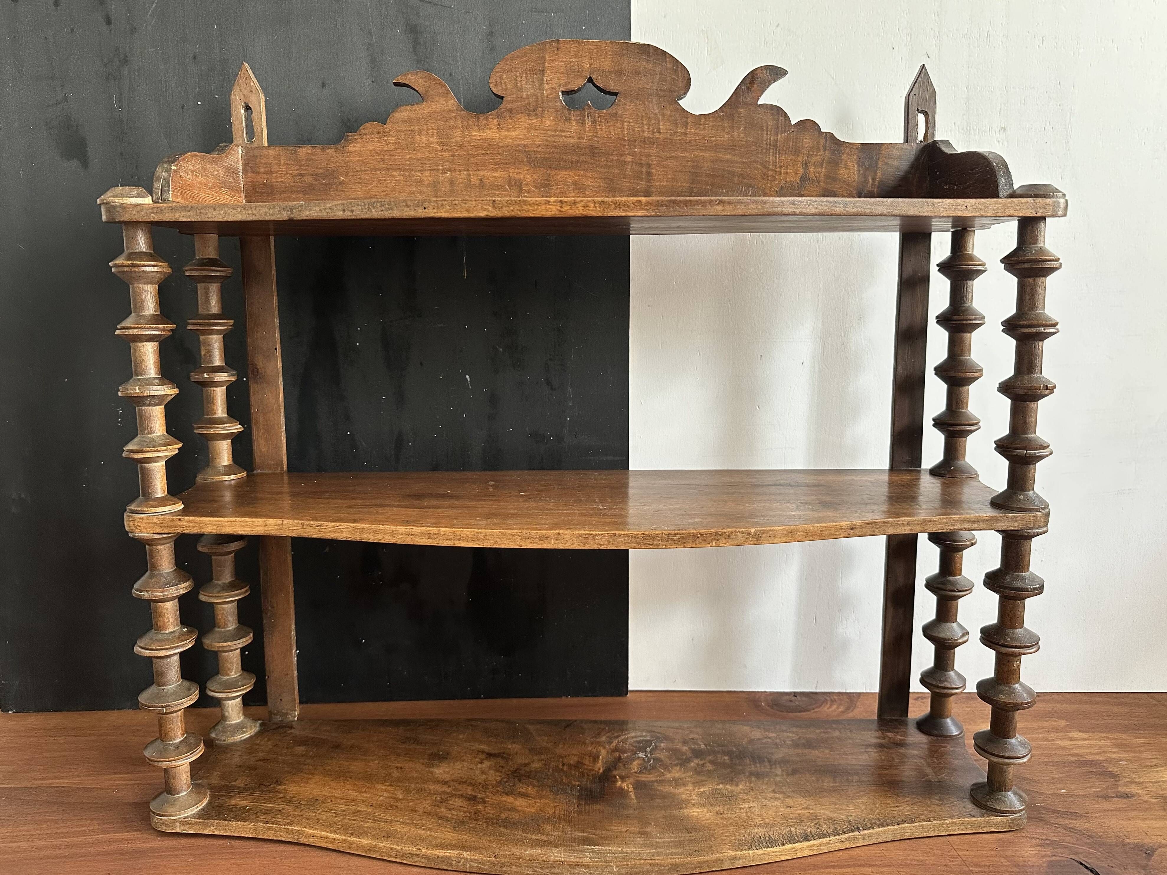 Antique wall shelf made of turned wood and spools of thread, late 19th century.