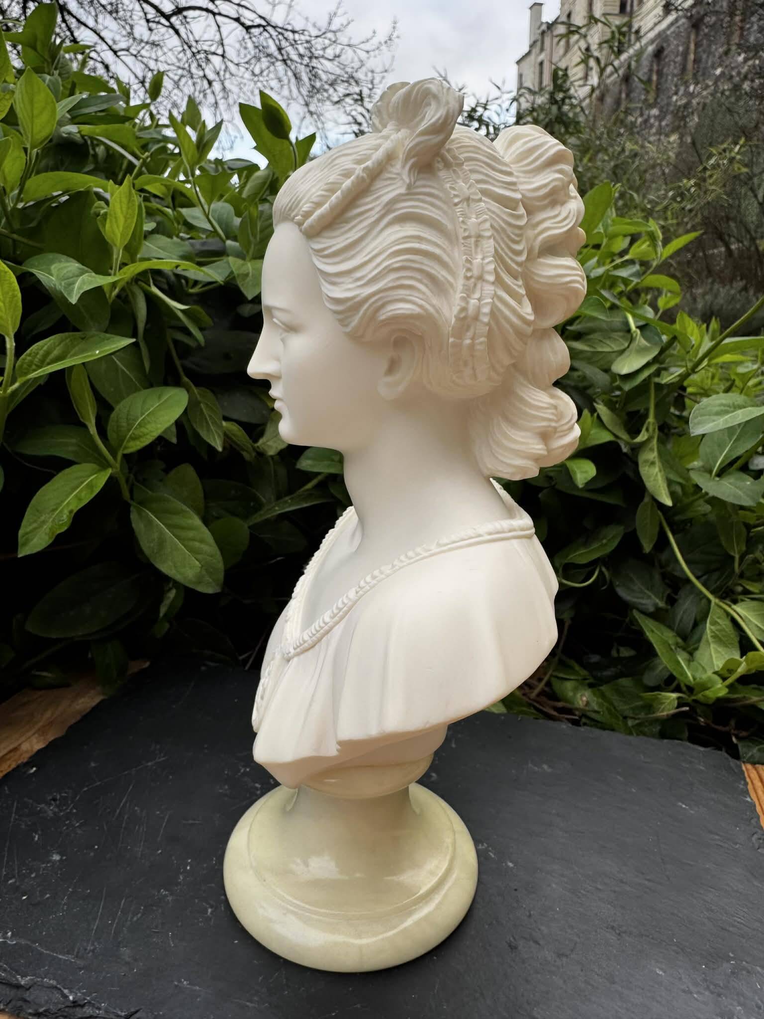 Alabaster bust of a woman signed Arnaldo Giannelli dated 1980.