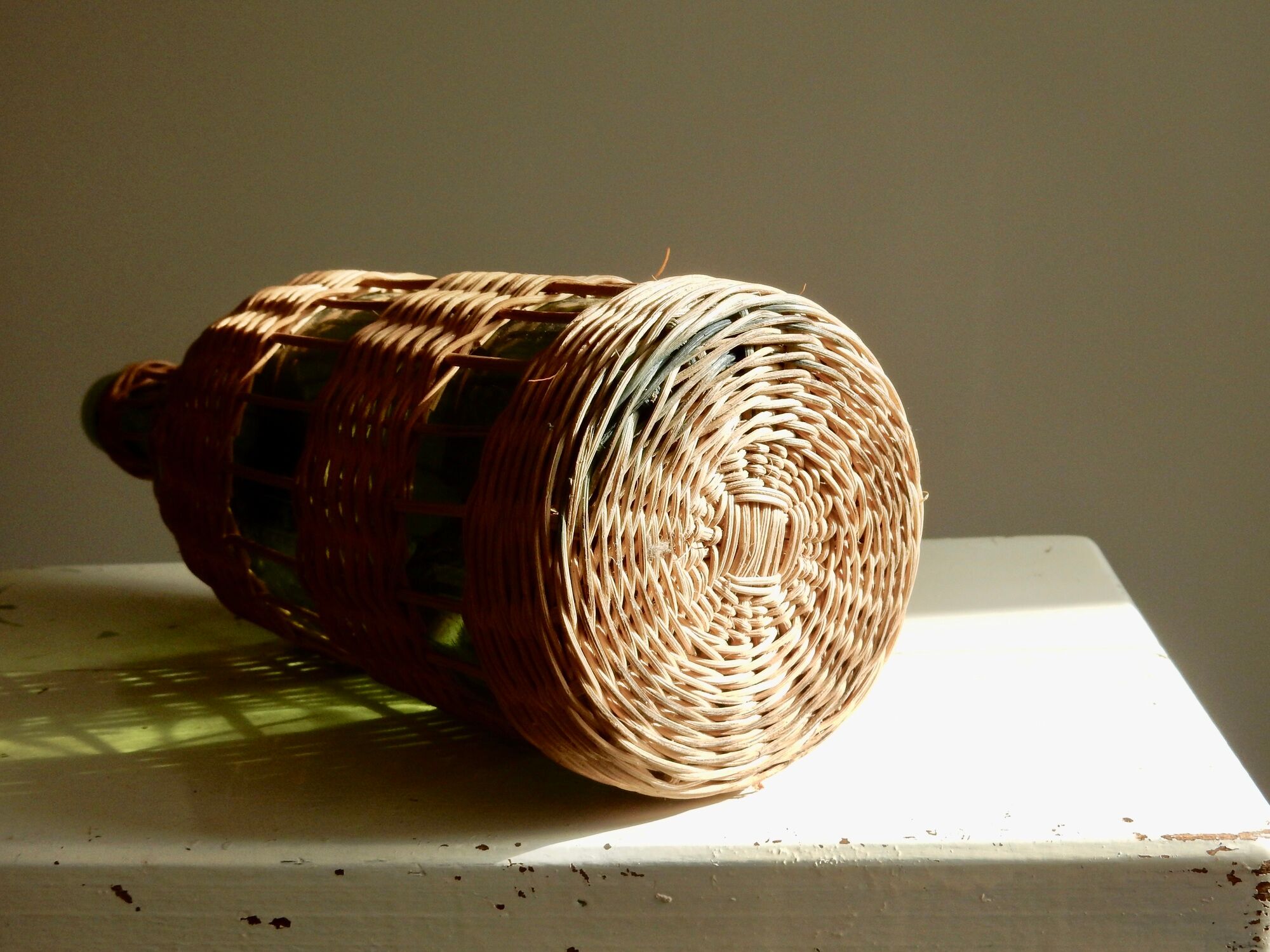 Glass bottle covered with wicker, France of the 60