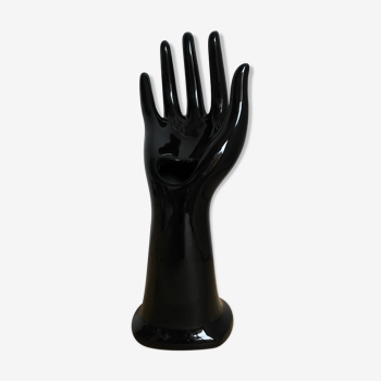 Hand wears vintage black ceramic ring 1970