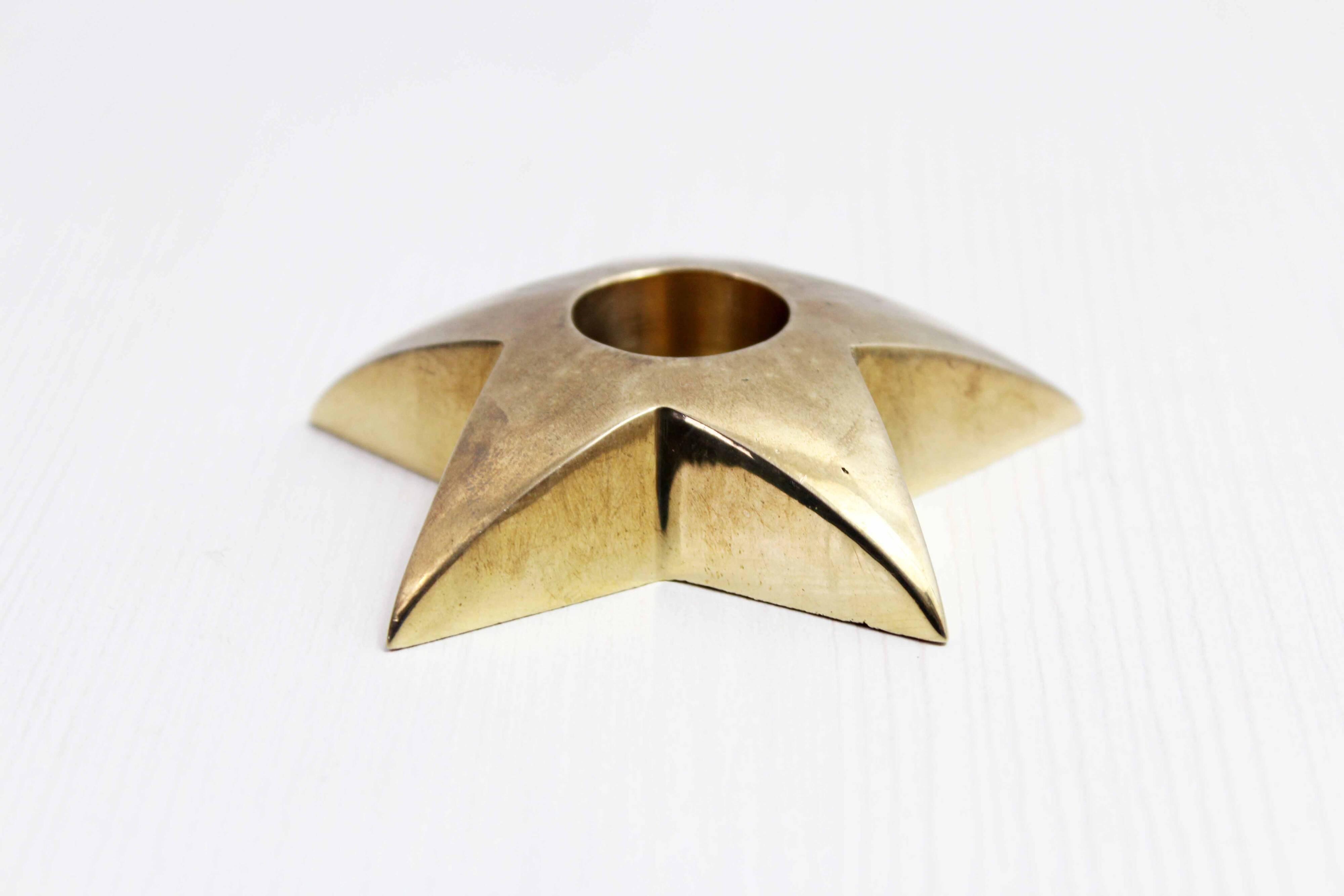 Star-shaped brass candle holder