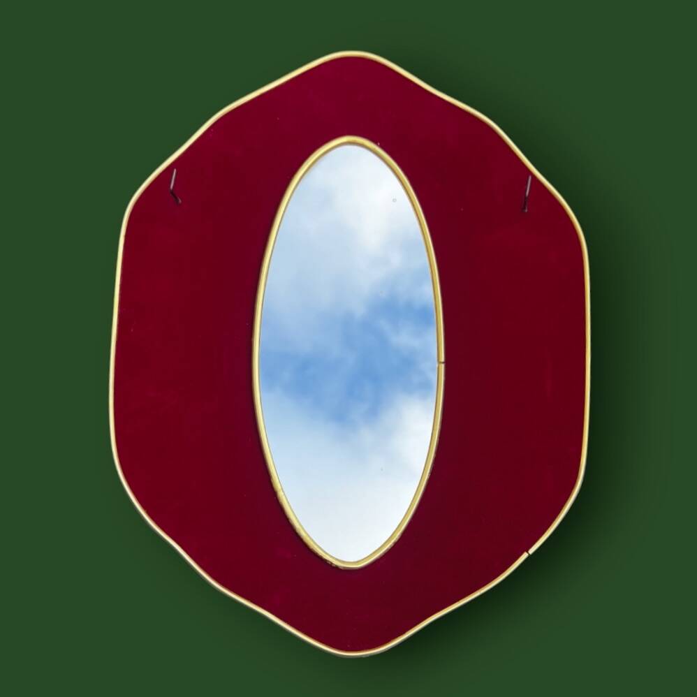 Oval wall mirror in burgundy velvet and brass – 1950s–1960s