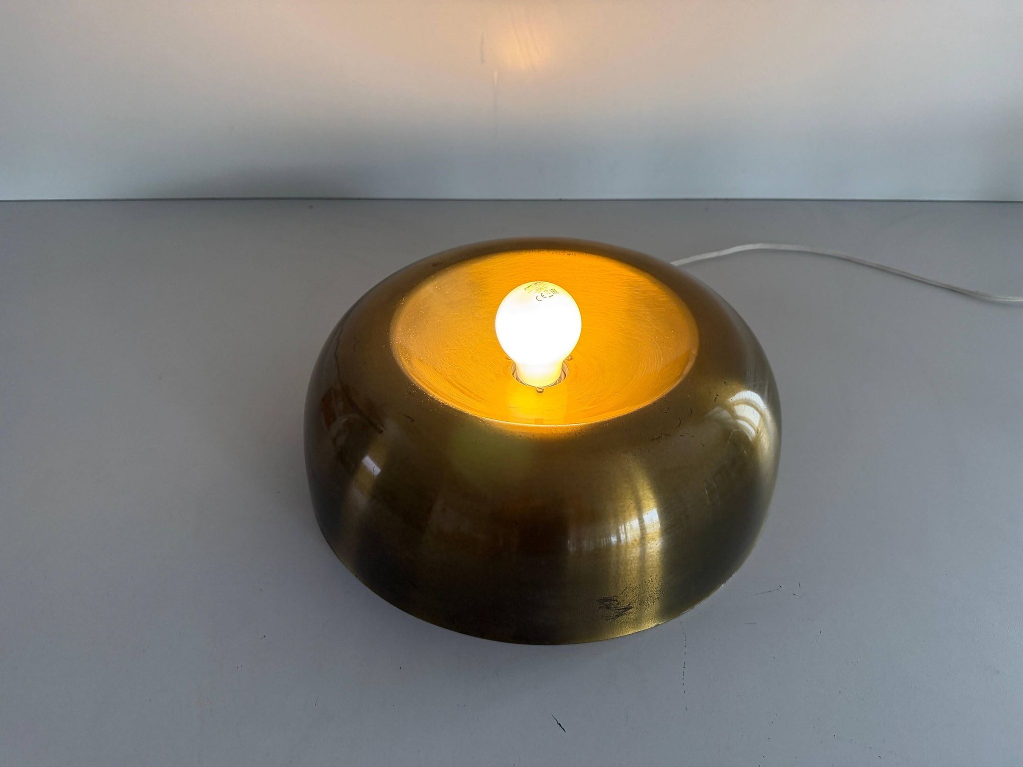 Flush-mounted disc-shaped brass fixture from the mid-century, 1960, Italy.