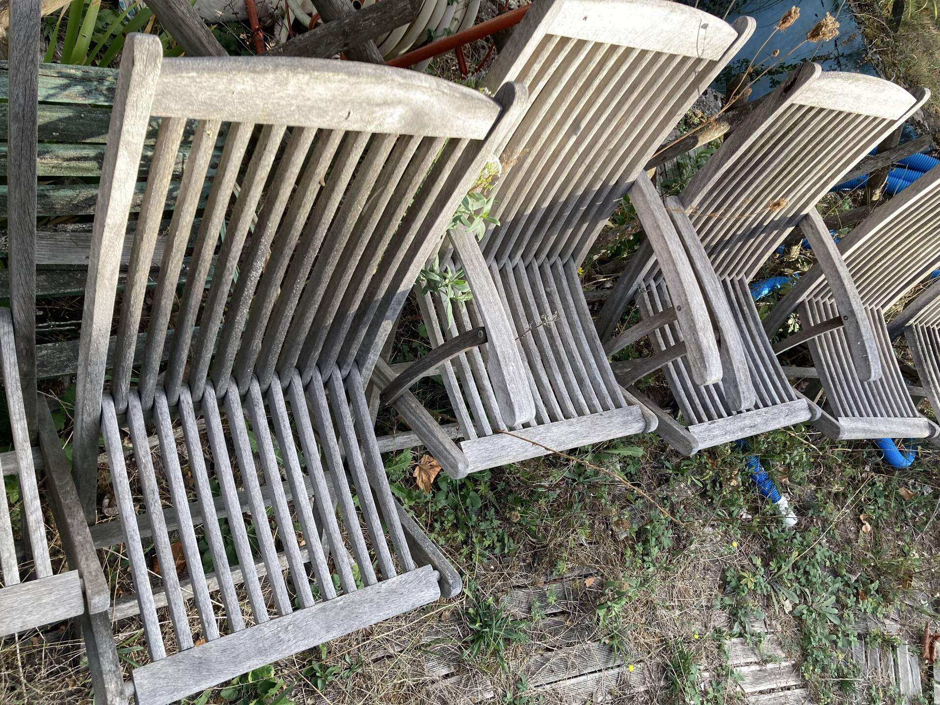 Folding garden chairs and armchairs in River Han dowelled teak.