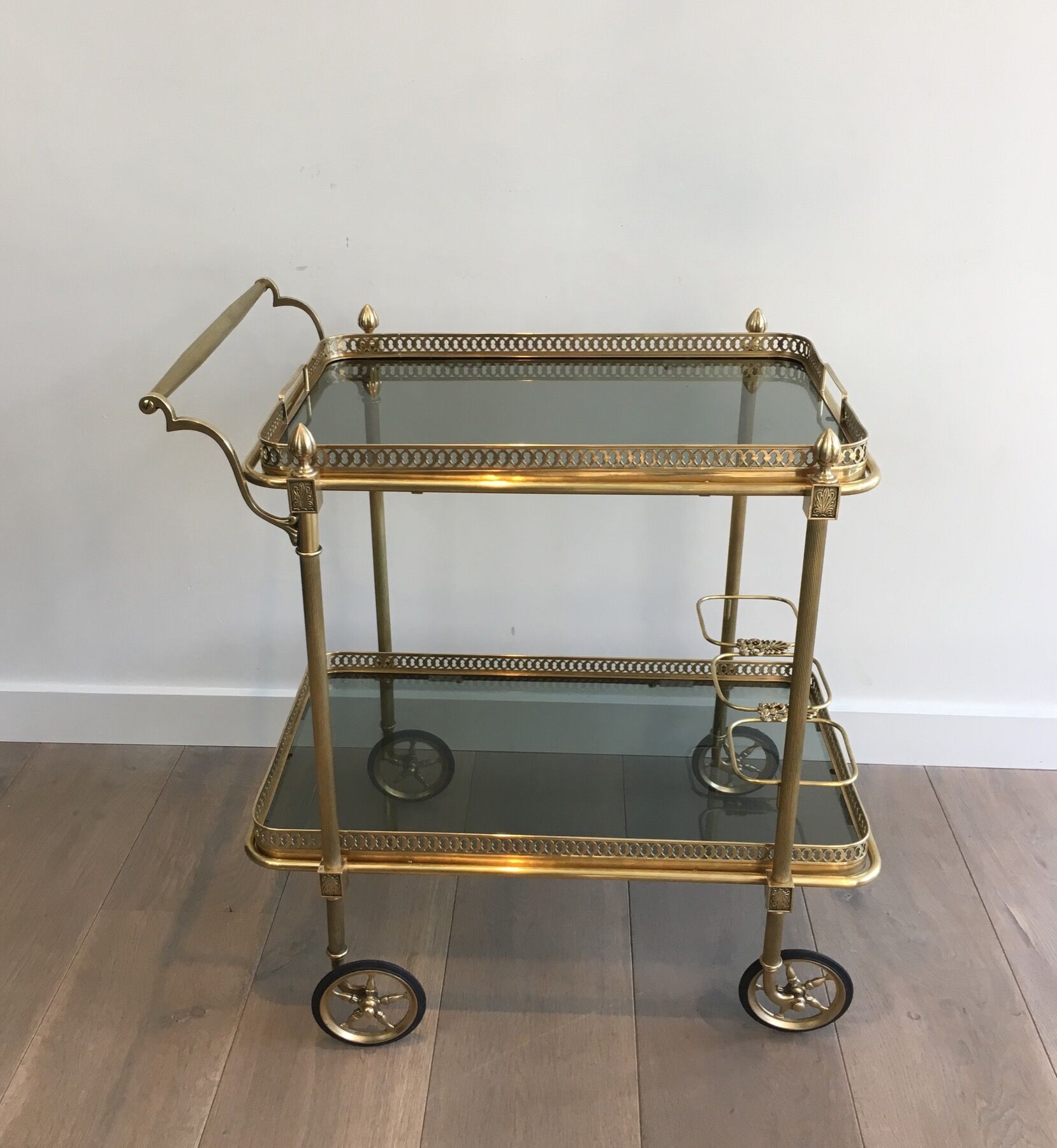Neoclassical style rolling table in brass with blue glass tops