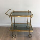 Neoclassical style rolling table in brass with blue glass tops