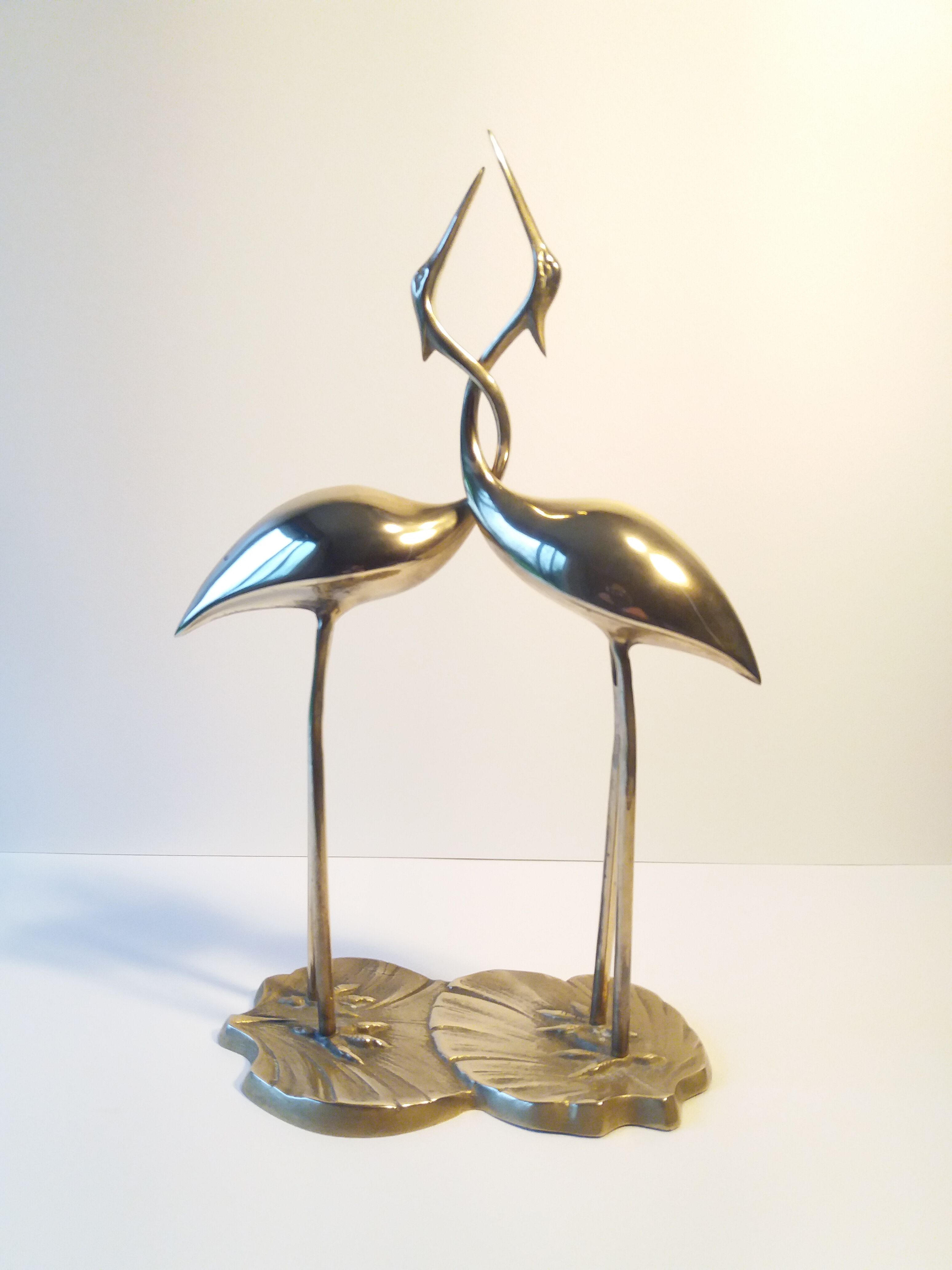 Herons entwined brass