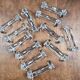 Set of 12 antique knife and fork rests in thick transparent glass.