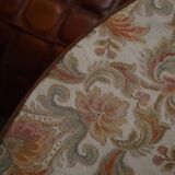 19th-century French round wine table with an adjustable top and floral textile surface.