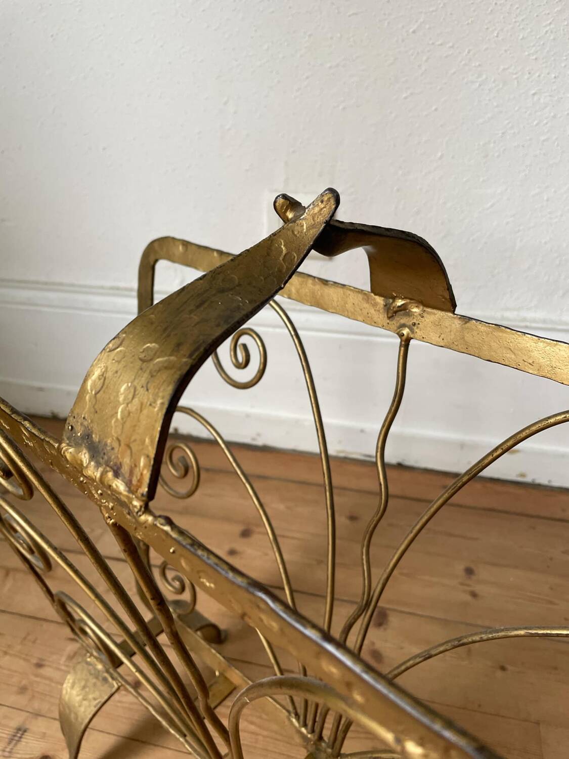 Vintage wrought iron magazine rack with gold butterfly design