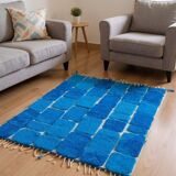 Handmade traditional pure wool carpet with blue patterns.