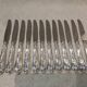12 silver-plated dessert knives by St Medard, rocaille style, Florian.