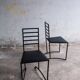 Set of 4 minimalist black steel dining chairs.
