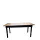 Oak farmhouse table with turned black legs.