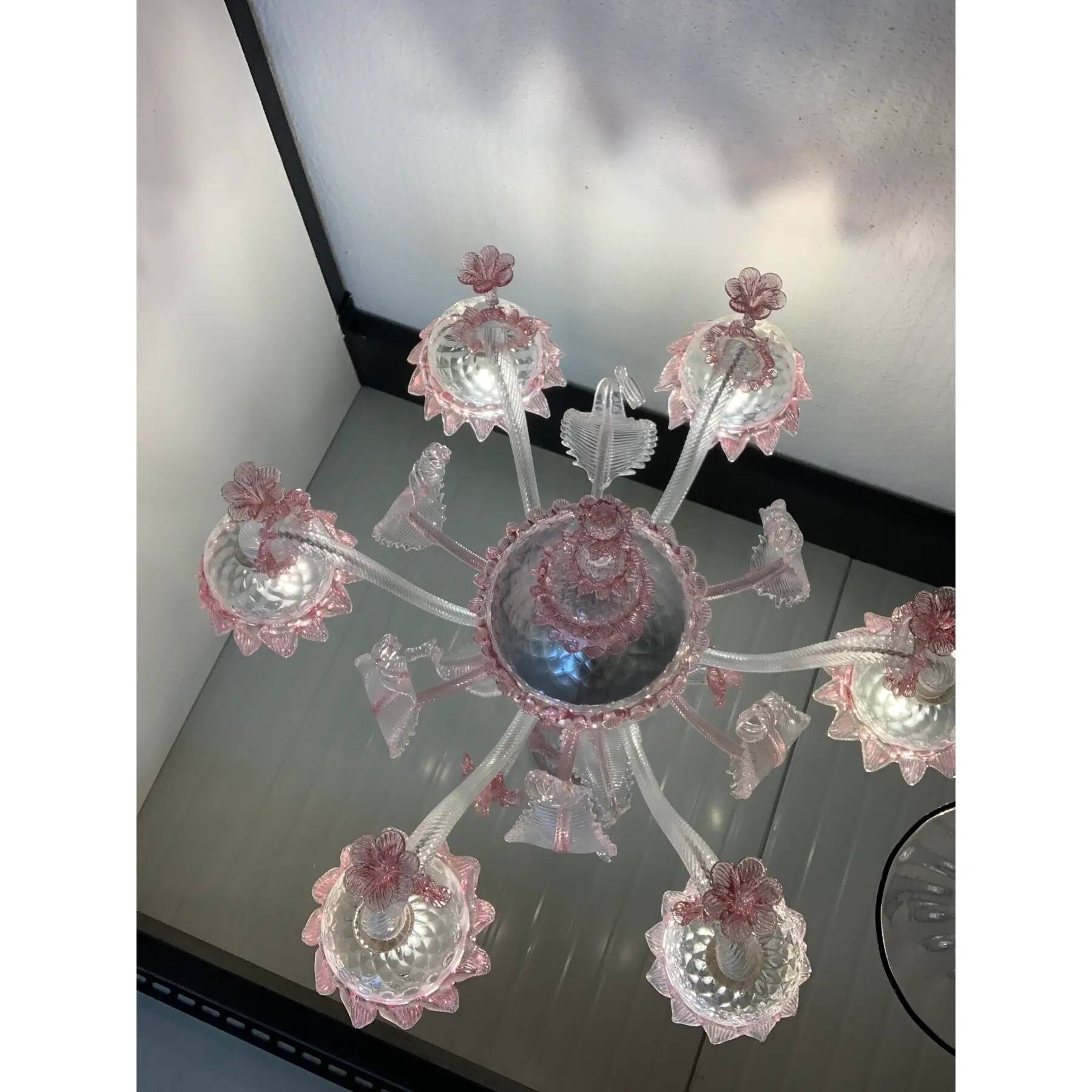 Chandelier in transparent and pink Murano-style glass with flower and leaf.
