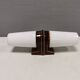 Old bathroom lamp with brown/golden ceramic base, porcelain socket and milky white glass