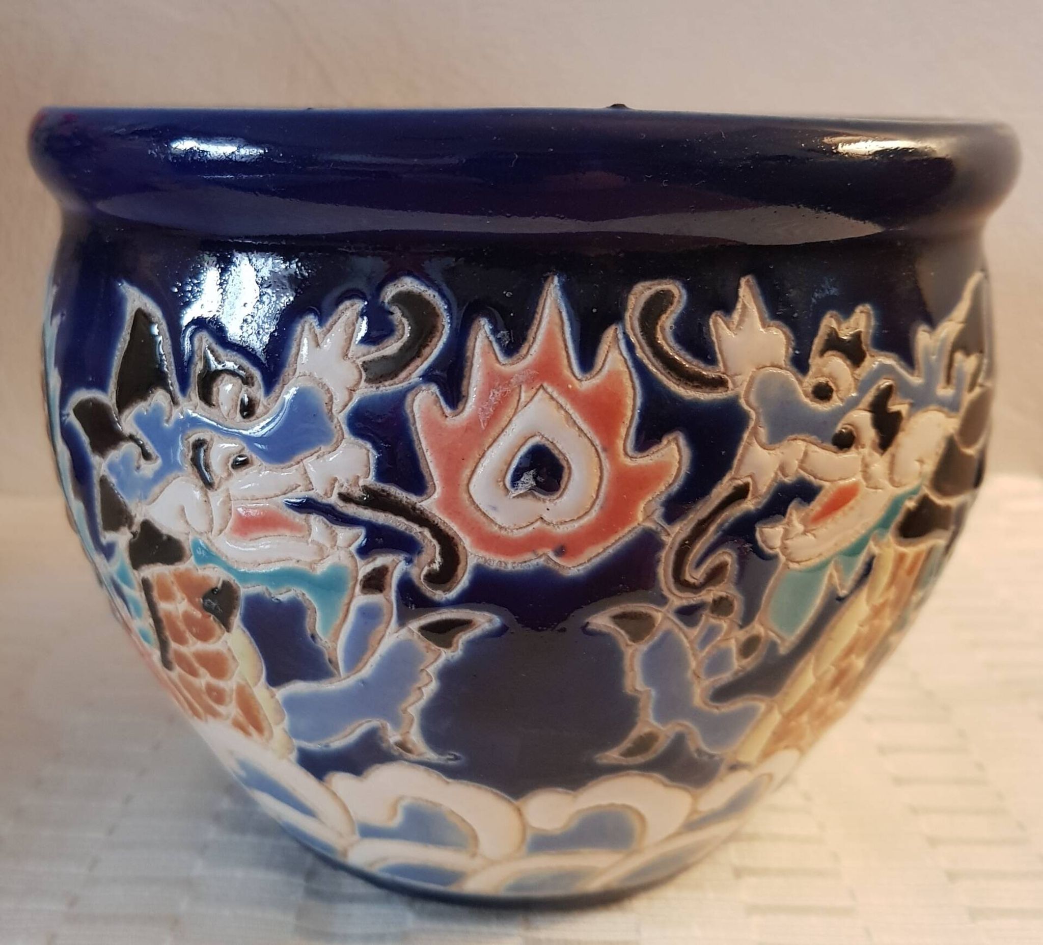 Decorative pot in multicoloured relief glazed ceramic.