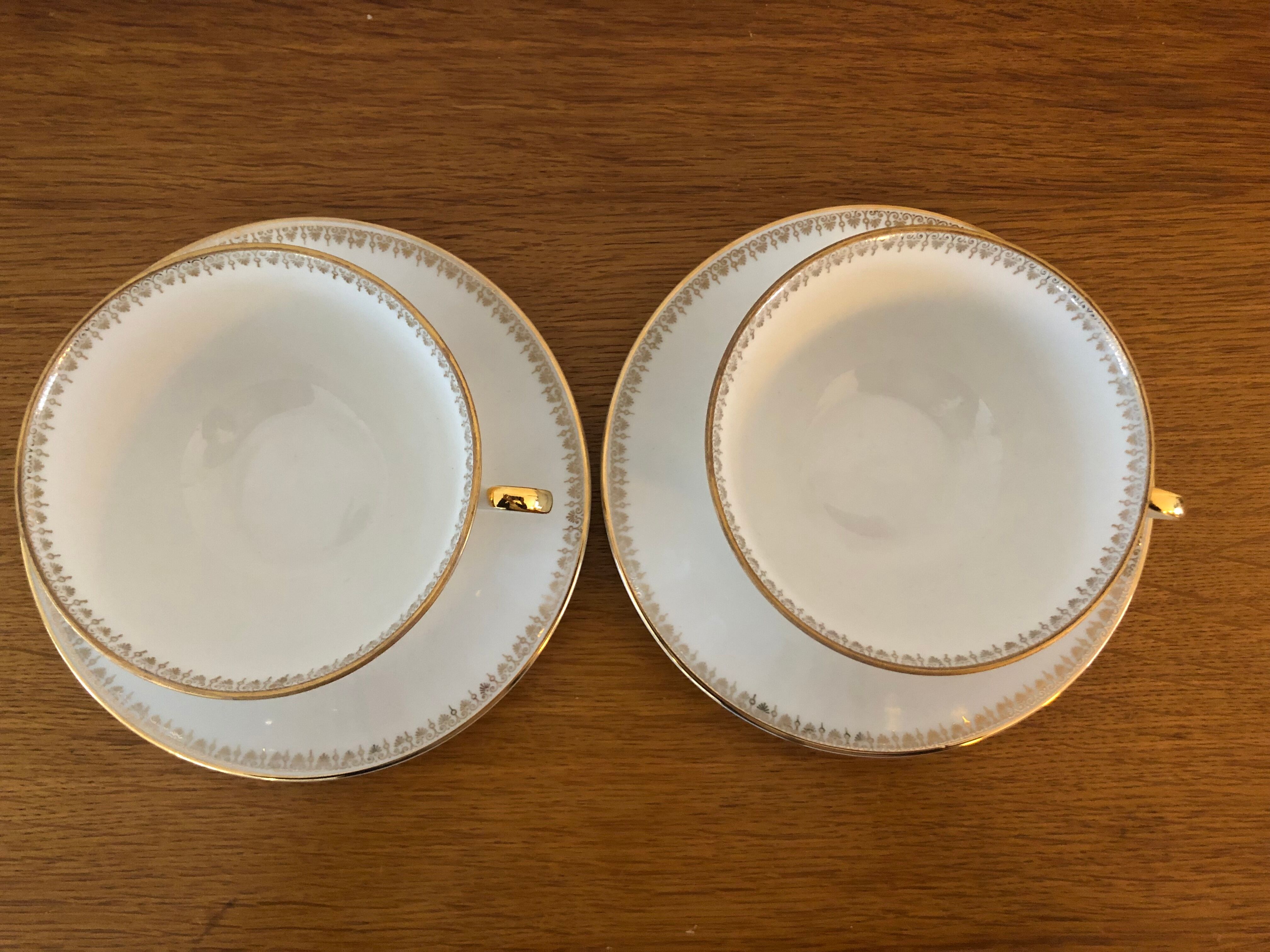 2 porcelain teacups and under teacups floral motifs