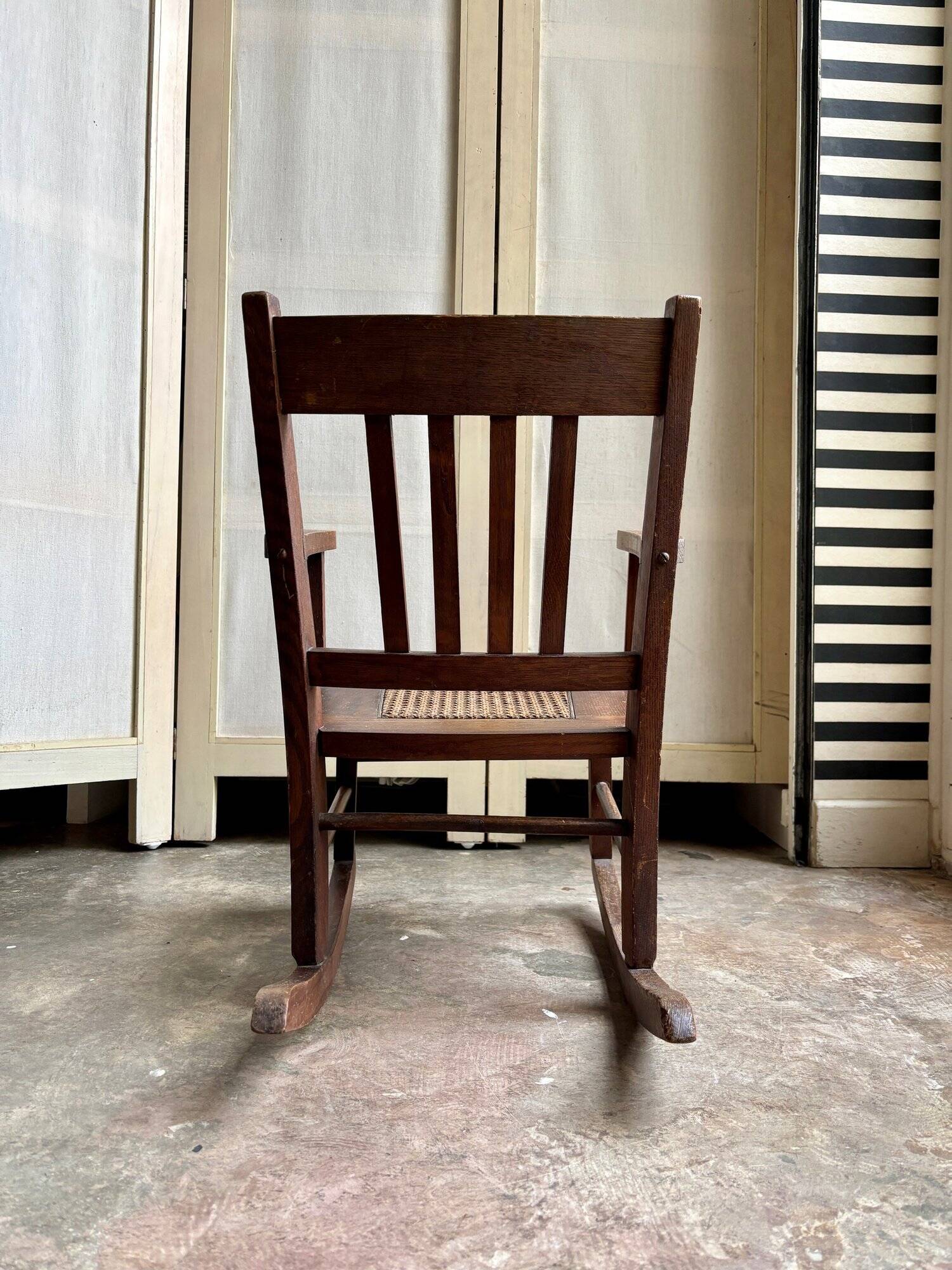 Children's rocking chair in dark wood and cane