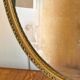 Gold oval mirror - mercury glass