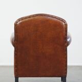 Sheep leather design armchair finished with decorative nails and black piping