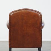 Sheep leather design armchair finished with decorative nails and black piping