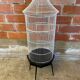 Antique black & white metal bird cage on vintage decorative legs