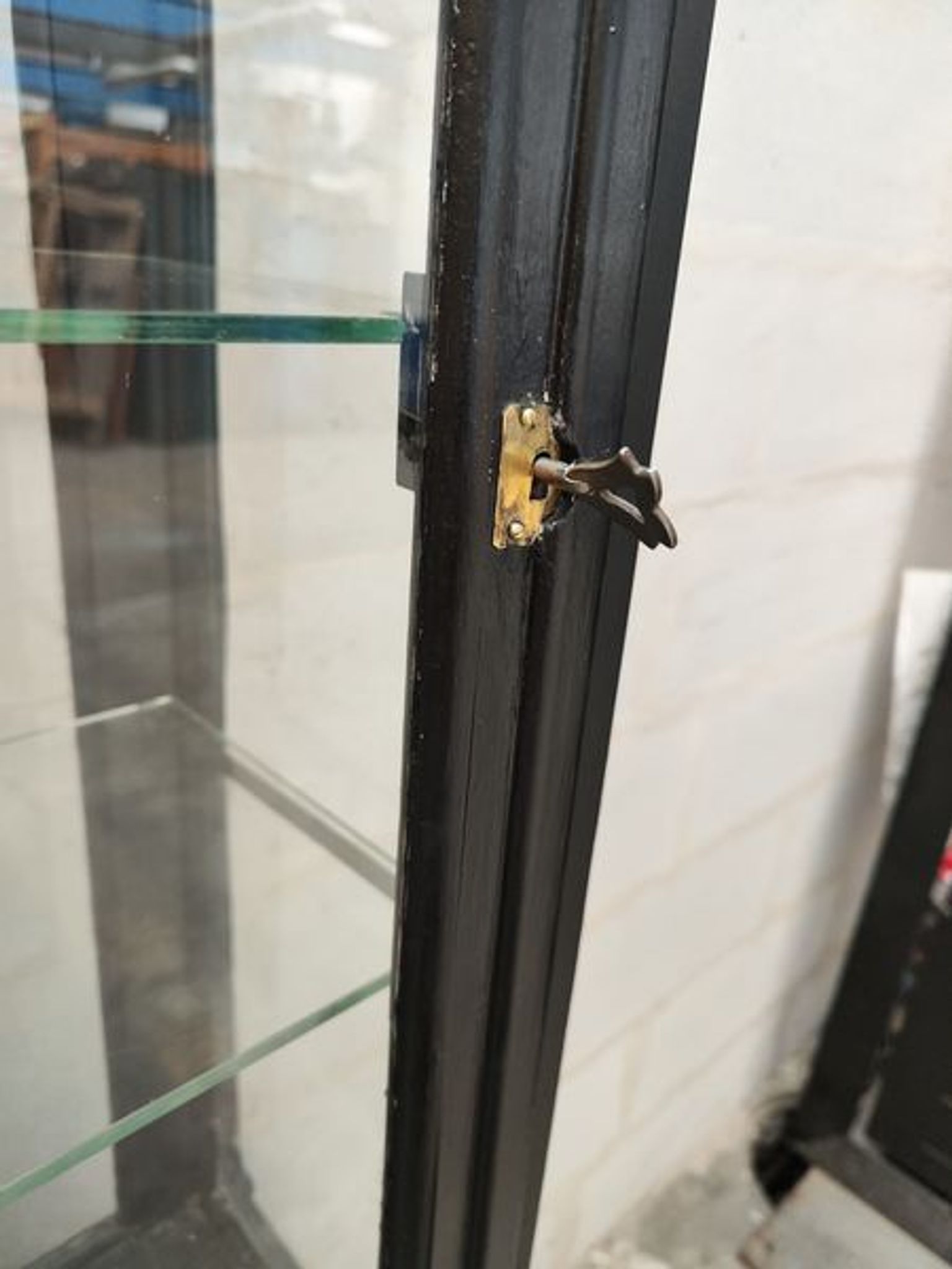 Old wooden window of black patina store two doors