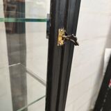 Old wooden window of black patina store two doors