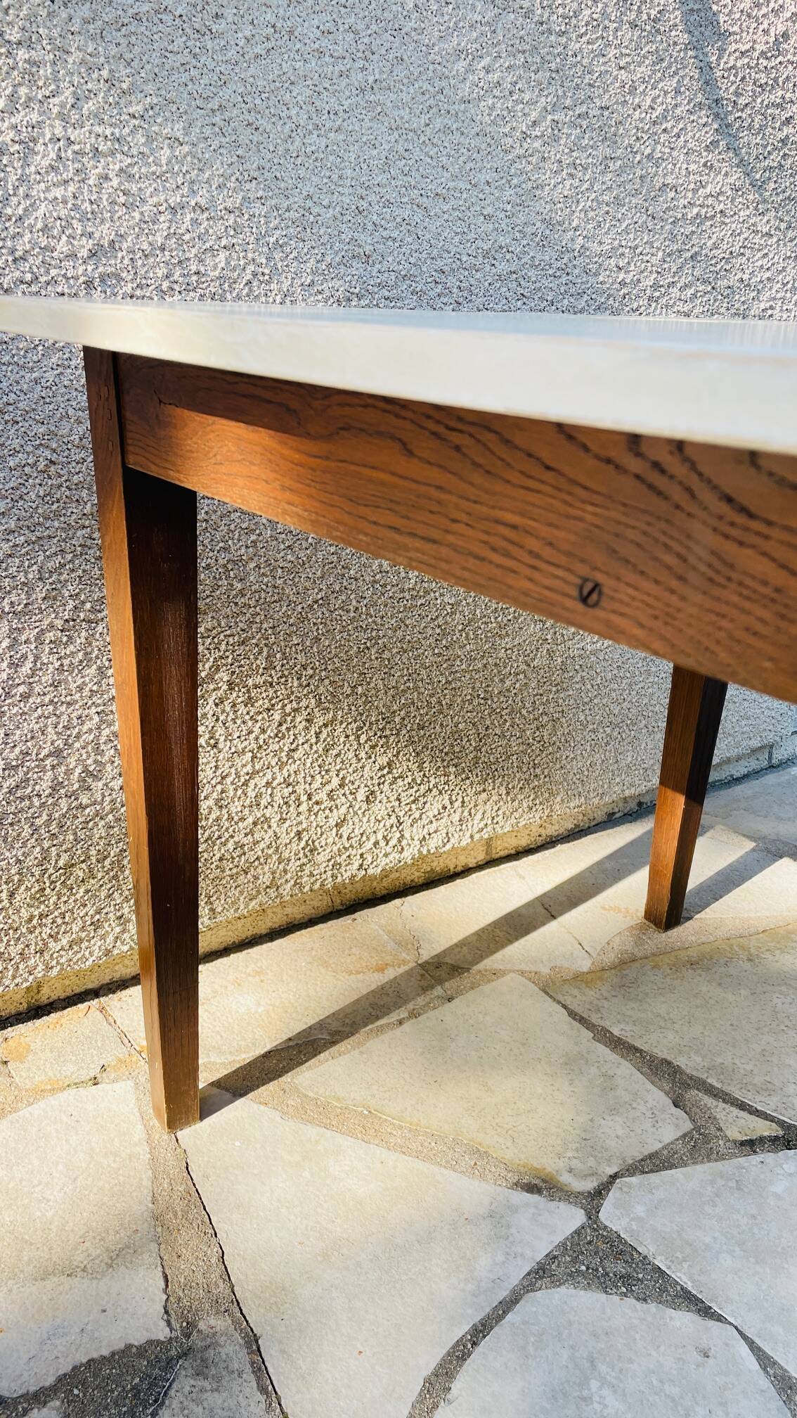 Vintage oak farmhouse table with a white top.